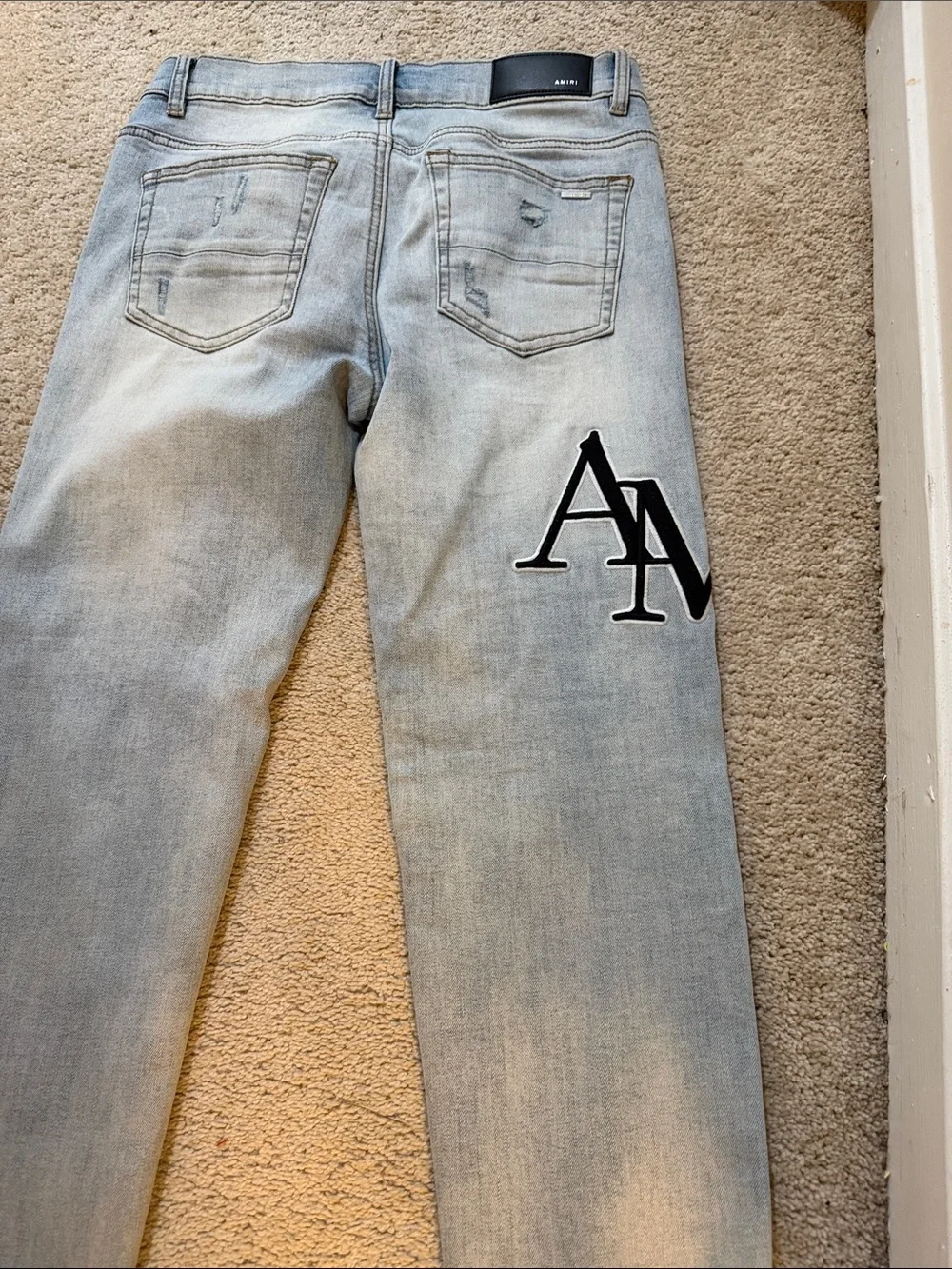 AMIRI Light Blue Slim Straight Jeans with Black Logo Patch
